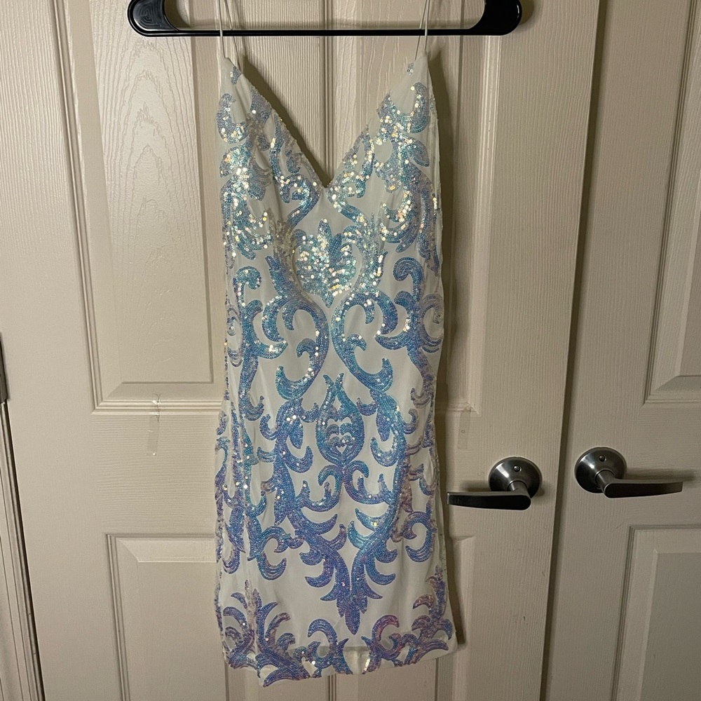 This dress is white with sequined patterns.